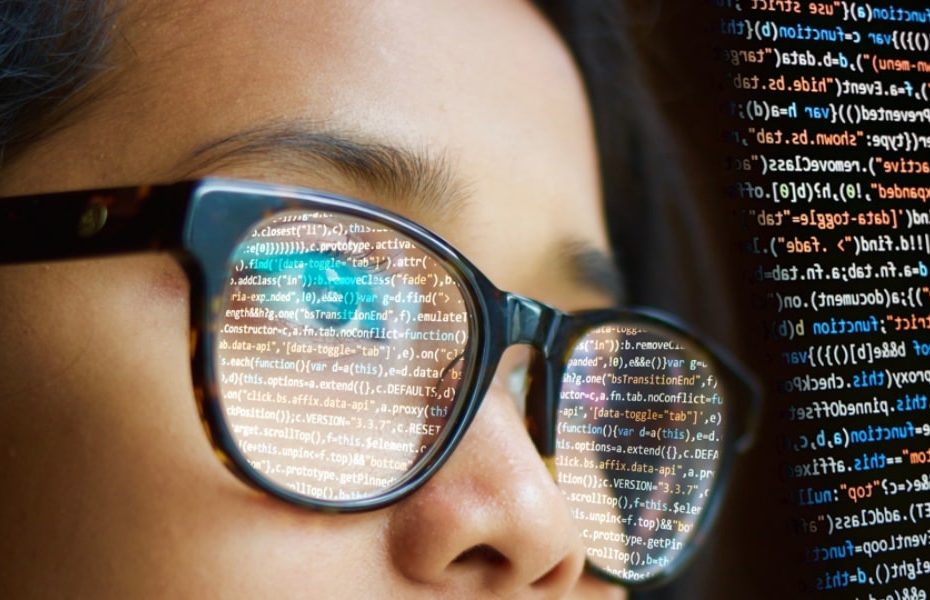 Woman of colour looking at code